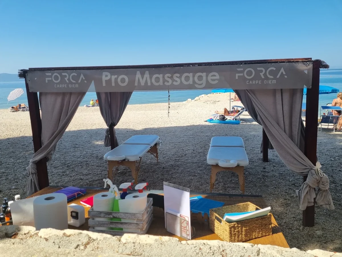 Two massage tables under the FORCA Pro Massage canopy on the beach in Makarska.
